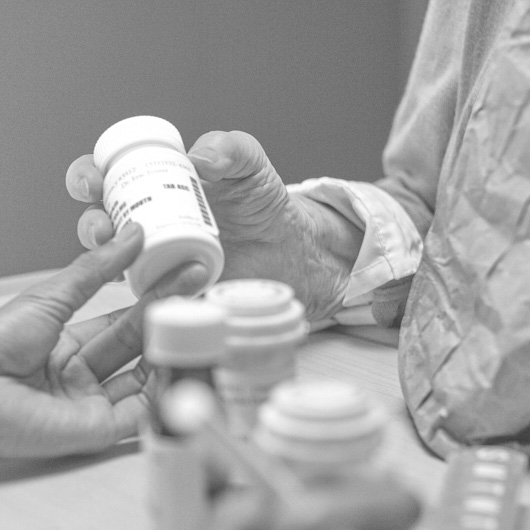 Senior Looking at Pill Bottle