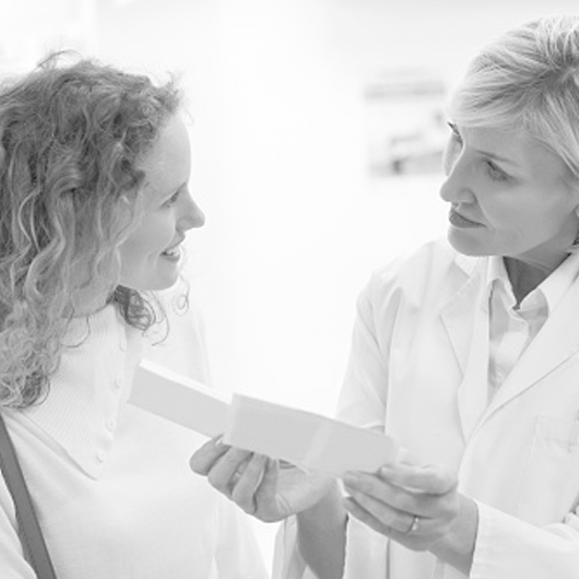 Female clinician counseling female patient